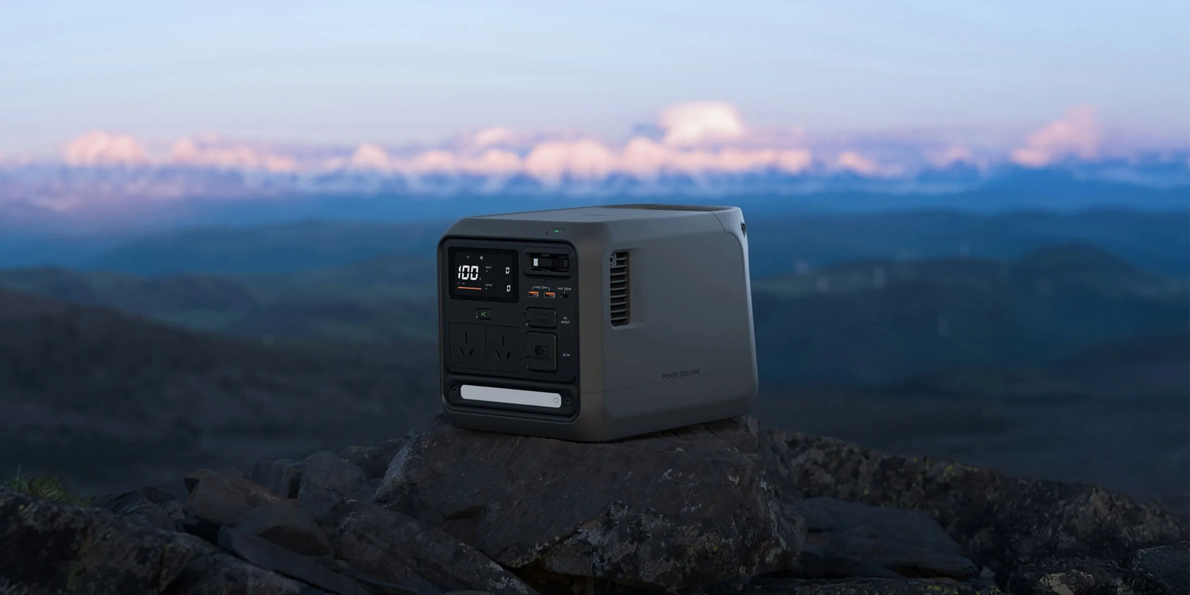 DJI Power 1000 Mini portable power station outdoors, showing the front controls and outlets