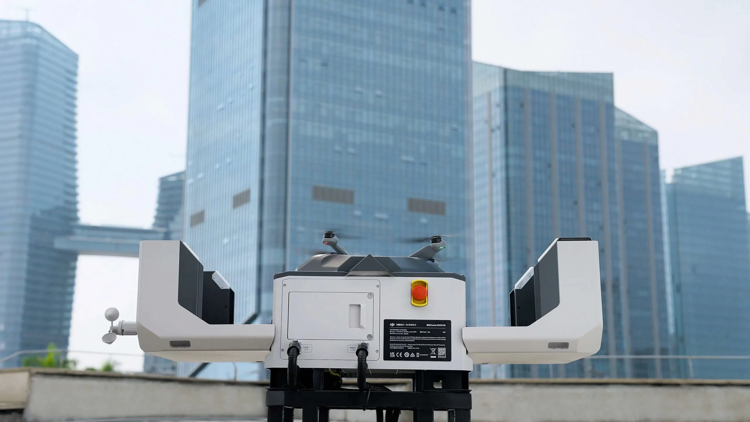 DJI Dock 2 automated drone dock with the lid open and a Matrice 3D aircraft on the landing pad