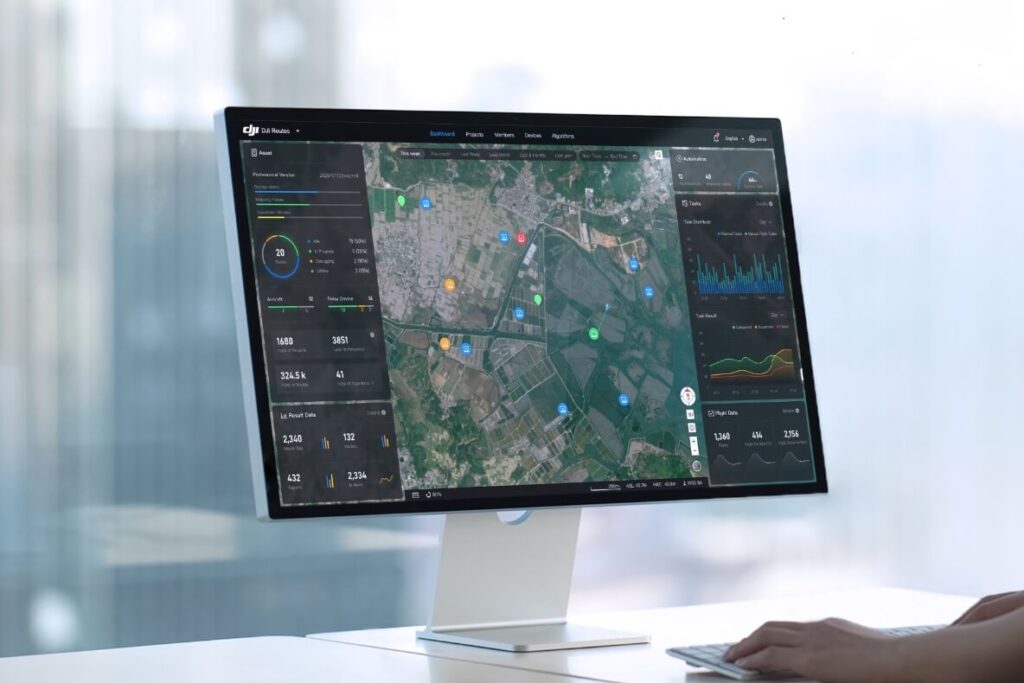 DJI FlightHub 2 dashboard showing a fleet map and flight statistics on a desktop monitor