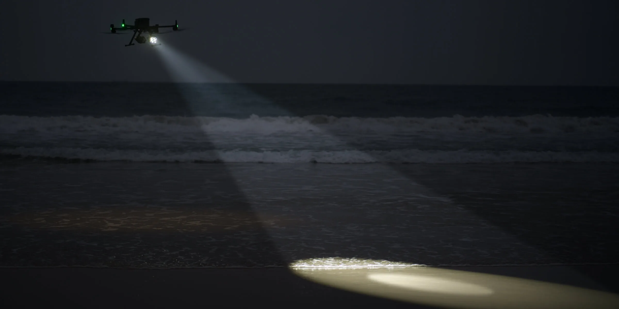 Zenmuse S1 spotlight beam lighting a night scene from the air