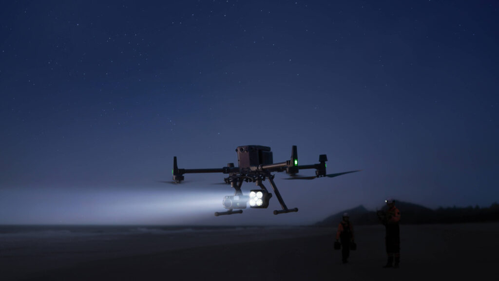 DJI Matrice 400 lighting the ground with the Zenmuse S1 spotlight at night
