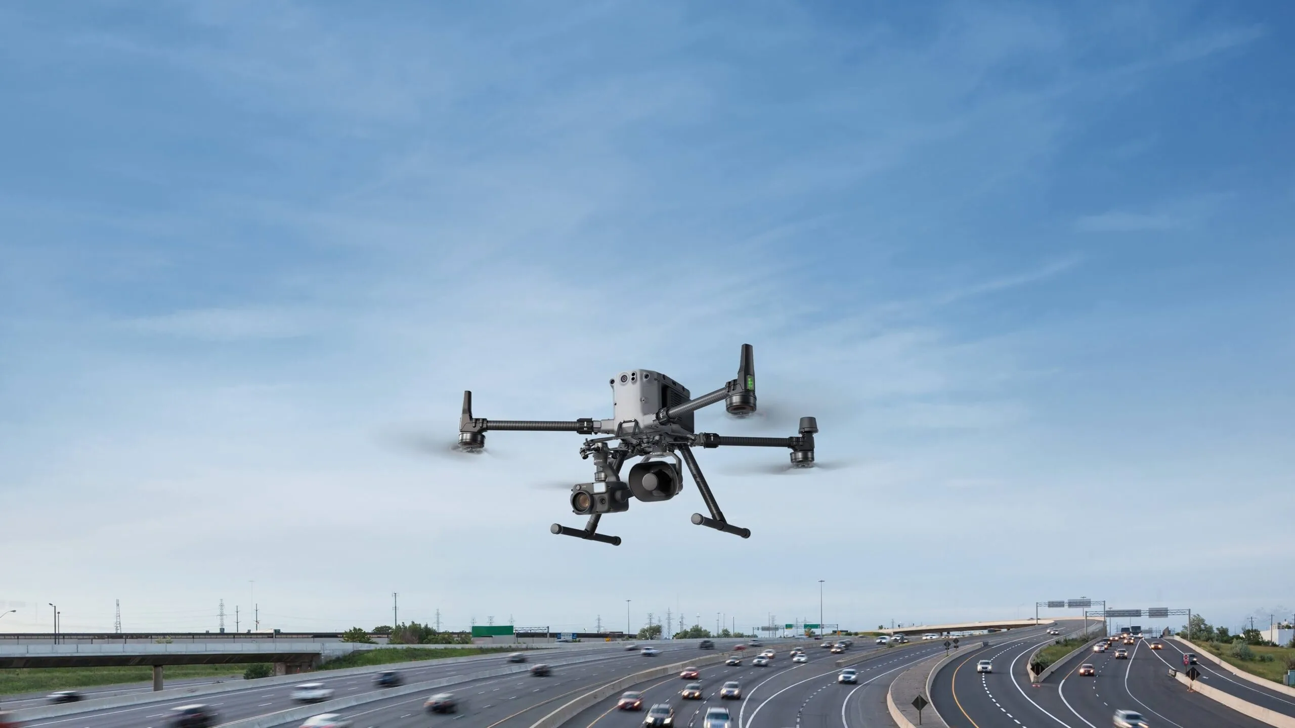 DJI Matrice 400 in flight carrying the Zenmuse V1 speaker